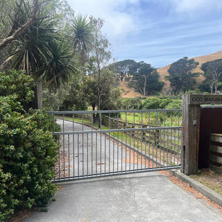 A solid metal gate blocks a driveway.