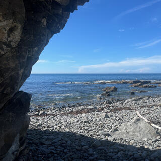 Viewing the beach from the shade of a shallow cave.