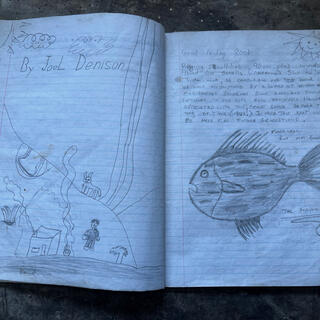 A pencil sketch by JoeL Denison depicting a fire outside the cave, and a sketch of a fish named ʼThe Phantomʼ.