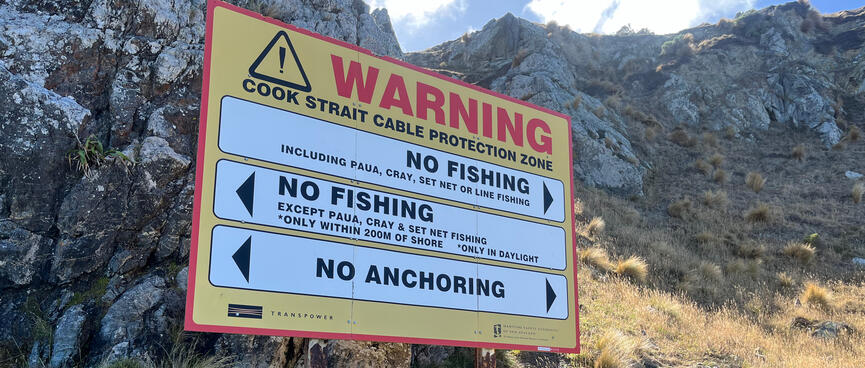 A large warning sign prohibits fishing and anchoring in the Cook Strait Cable Protection Zone.
