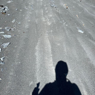 My shadow straddles a long depression in the fine beach shingle.