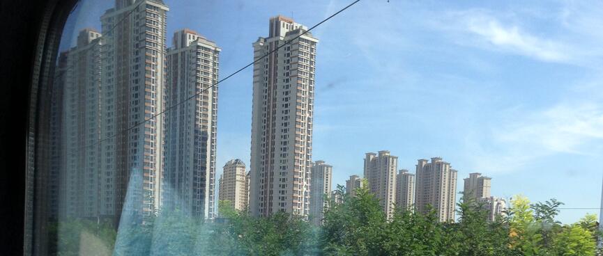 10 high rises buildings next to a grove of trees.