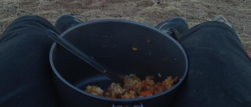 A pot of risotto rests on my lap as I take in a panoramic view of the steppe below.
