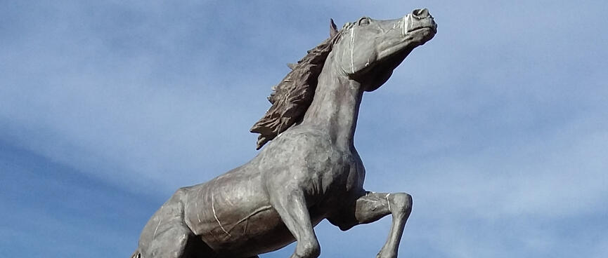 A statue of a stallion kicking its front legs into the air.