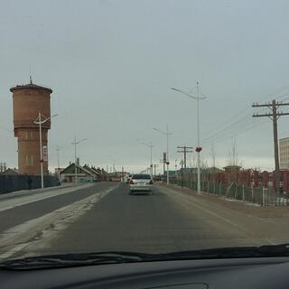 A round three storey tower on the side of the road.