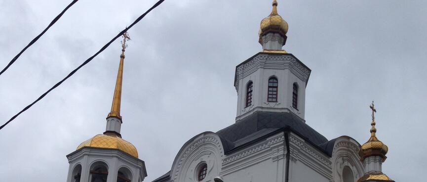 Golden spikes adorn the towers of a white church in old Irkutsk.