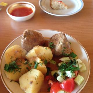 Meatballs, potatoes, and tomato and cucumber salad.