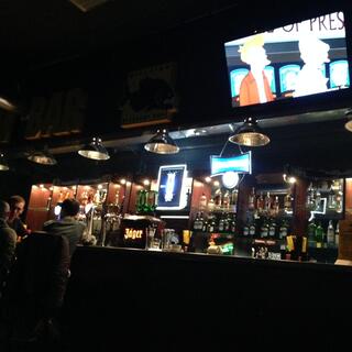 Above the bar, Futurama plays on a flatscreen TV.