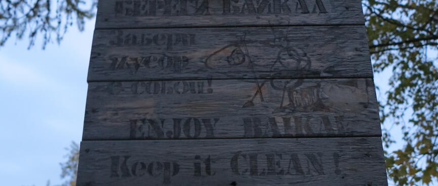 A wooden sign reads: ENJOY BAIKAL. Keep it CLEAN!