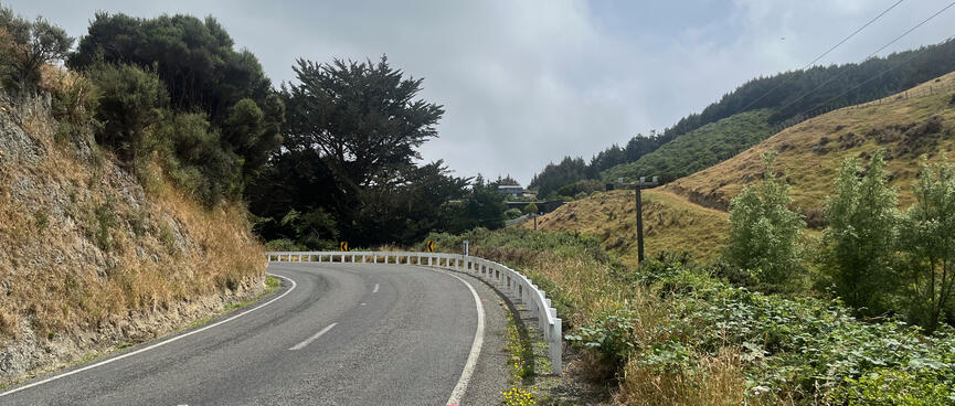 The road disappears around a blind left hand corner.