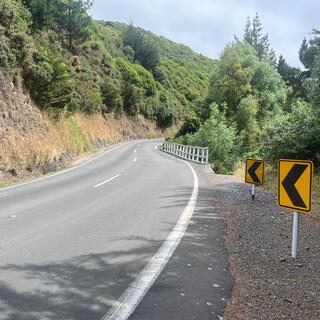 The road disappears around a blind right hand corner.