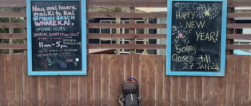 Blackboards at Mākara Cafe say 'Sorry closed till 27 Jan 24'.