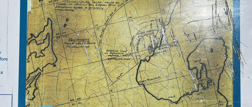 A blue signboard has a yellow map showing the range of the 6' guns.