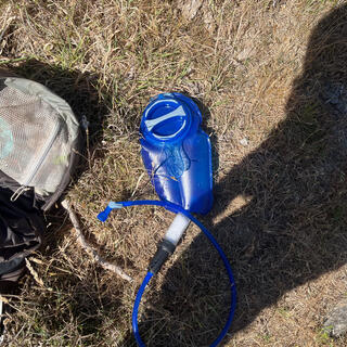 A blue Camelbak hydration bladder with attached drinking hose and LifeStraw 2-stage filter.