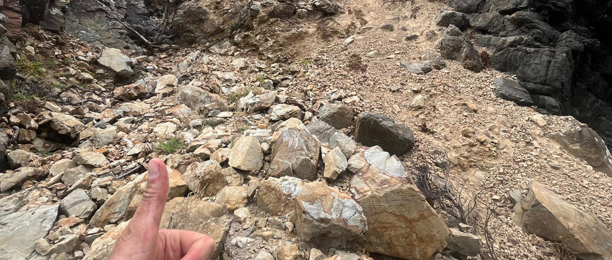 Giving a thumbs-up at the bottom of a loose rocky descent.