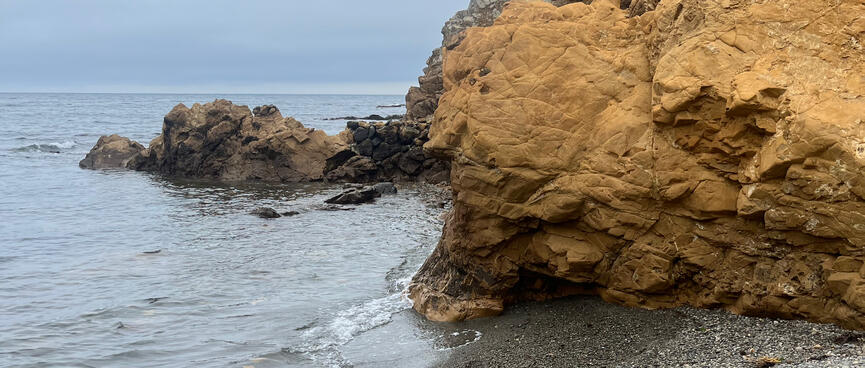 Looking back at the rocky hillside which runs into the sea.
