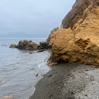 Looking back at the rocky hillside which runs into the sea.