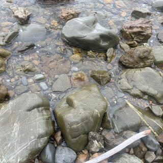 Slightly green rocks amongst grey rocks.