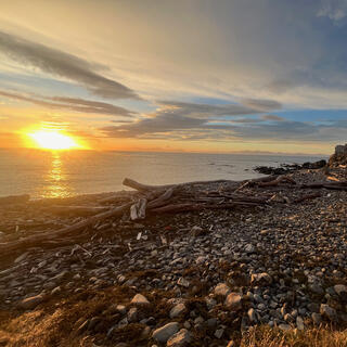 The golden sun looks like a fireball as it hits the sea.
