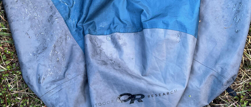 Droplets of water on the exterior of an Outdoor Research bivvy sack.