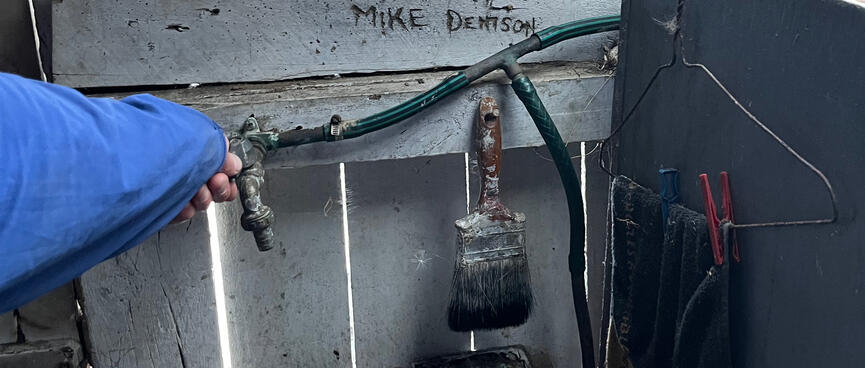 A metal tap above a porcelain basin.