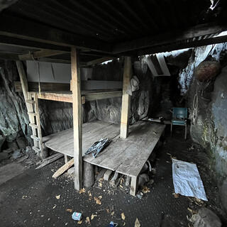A low wooden platform and bunkbed frame with ladder.