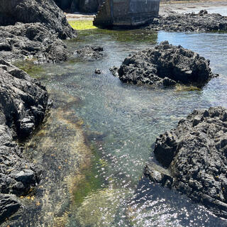 A pool of water ringed by rocks.