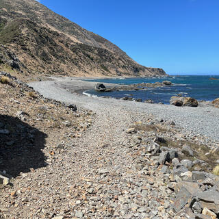 A wide pebbly path runs around the bay.