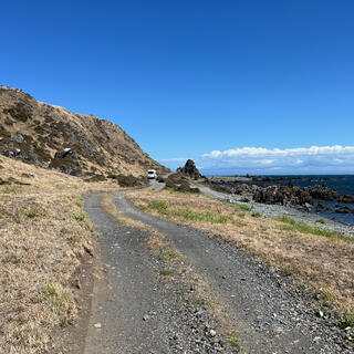 A large white campervan on the coastal road.
