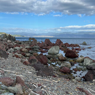 Grey and crimson rocks in the sea.