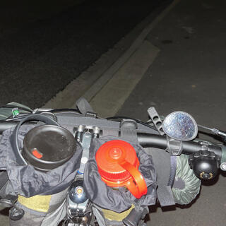 The loaded cockpit of my bicycle on a dark suburban street.