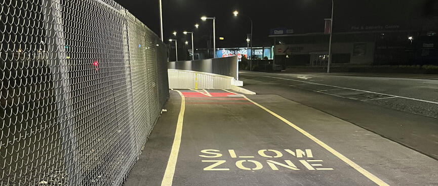 A cycleway is signposted with SLOW ZONE where it heads underground.
