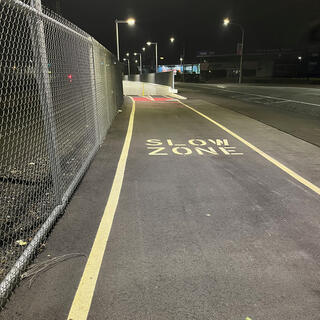 A cycleway is signposted with SLOW ZONE where it heads underground.