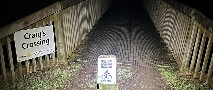 A short wooden bridge signposted as ‘Craigʼs Crossing‘ and ‘River Trail‘.