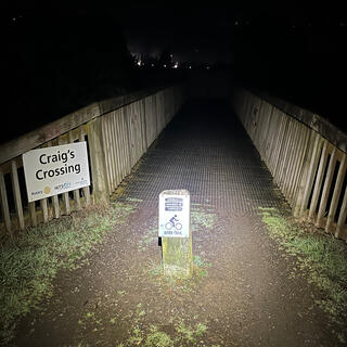 A short wooden bridge signposted as ‘Craigʼs Crossing‘ and ‘River Trail‘.