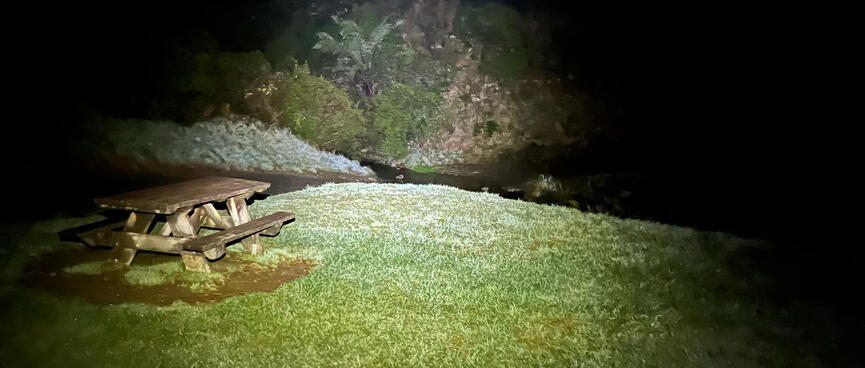 A picnic table and a small river.