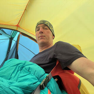 Lounging in my sleeping mat chair inside my new tent.
