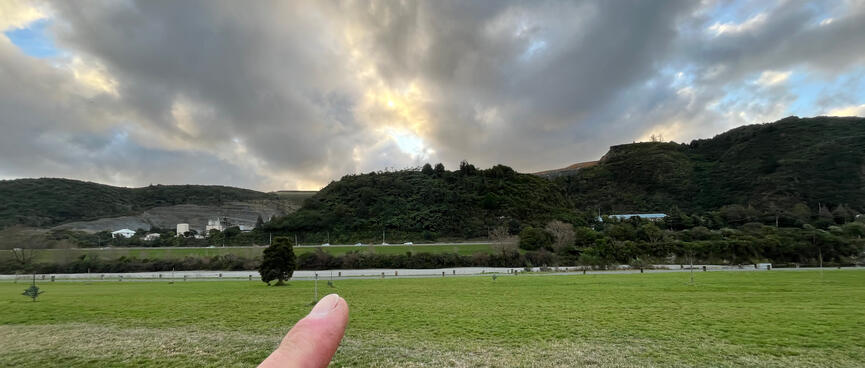 A scrubby hill next to a quarry.