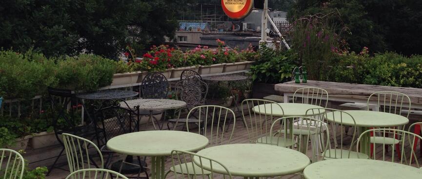 A sea of round tables and metal chairs.