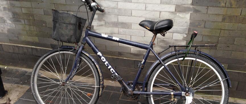 A simple black bicycle reads ʼPoliceʼ.