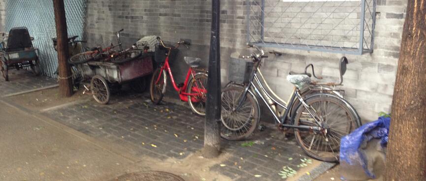 Ladies bicycles and a cart with bicycle wheels.