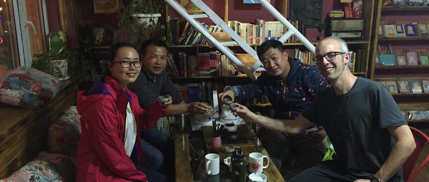 The four of us toast our tea cups.