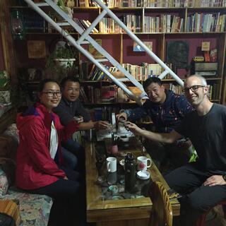 The four of us toast our tea cups.
