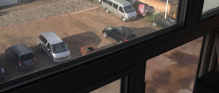 The street below is visible through multiple window panes.