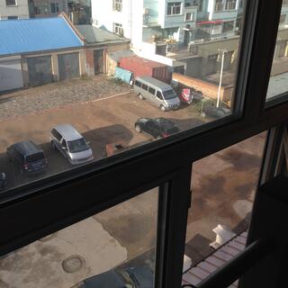 The street below is visible through multiple window panes.