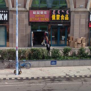 Standing outside a shop, local wears a Nike style t-shirt which reads ʼJust f*ck itʼ.