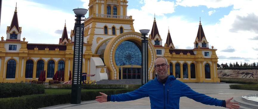 I spread my arms in front of an ornate clock tower.