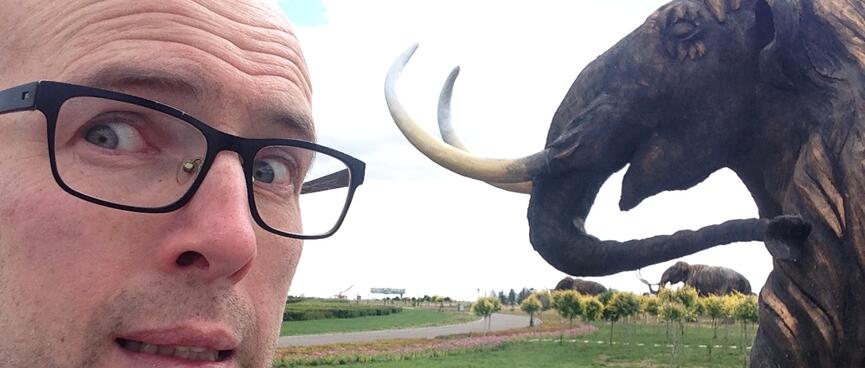 A mammothʼs sharp tusks are only inches away from my pale face.