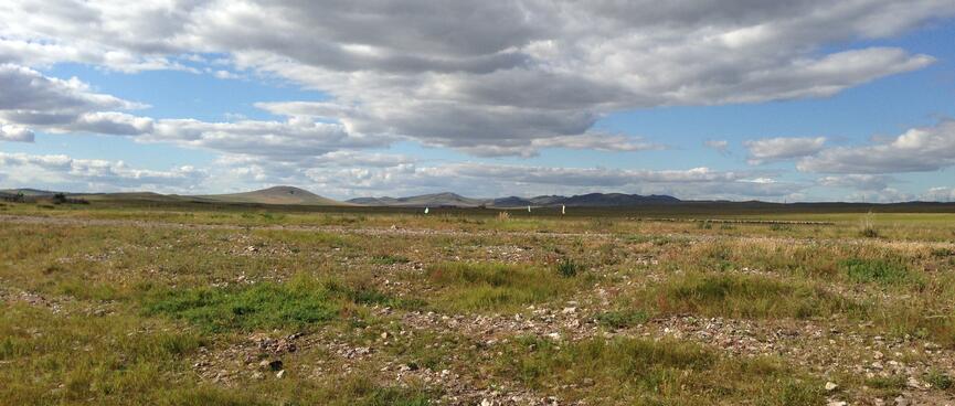 Shallow, shadowy mountains in the distance.