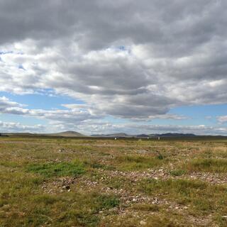 Shallow, shadowy mountains in the distance.